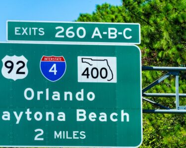 A green Florida highway sign for exits 260 A-B-C for inter- and intrastate highways toward Orlando and Daytona Beach.