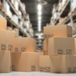 Several cardboard boxes are stacked in a large storage warehouse, illustrating an organized and structured environment.