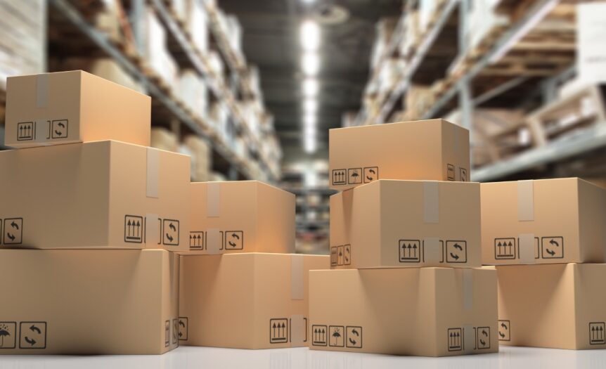 Several cardboard boxes are stacked in a large storage warehouse, illustrating an organized and structured environment.