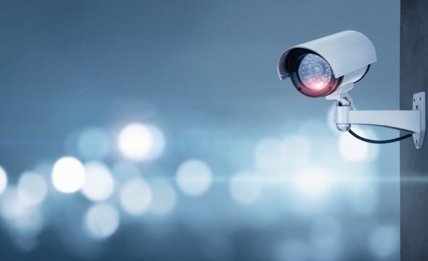 A CCTV camera positioned prominently, with a blurred background that emphasizes the camera's features.