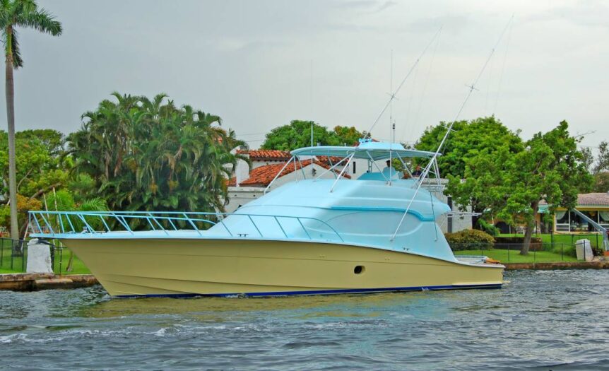 A boat with a new paint job of vibrant colors applied to its hull is surrounded by calm waves and a clear sky.