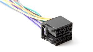 A black 8-cavity connector sits on a white surface with purple, orange, white, blue, red, green, and yellow wires.