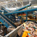 The interior of a recycling facility with conveyor belts that sort and separate recycling items from trash.