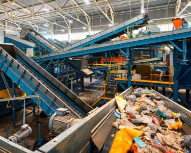 The interior of a recycling facility with conveyor belts that sort and separate recycling items from trash.