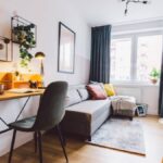 A close-up of the interior of a small apartment living room for a home office. The room has a modern-industrial look.