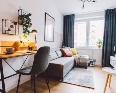 A close-up of the interior of a small apartment living room for a home office. The room has a modern-industrial look.