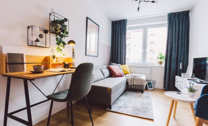 A close-up of the interior of a small apartment living room for a home office. The room has a modern-industrial look.