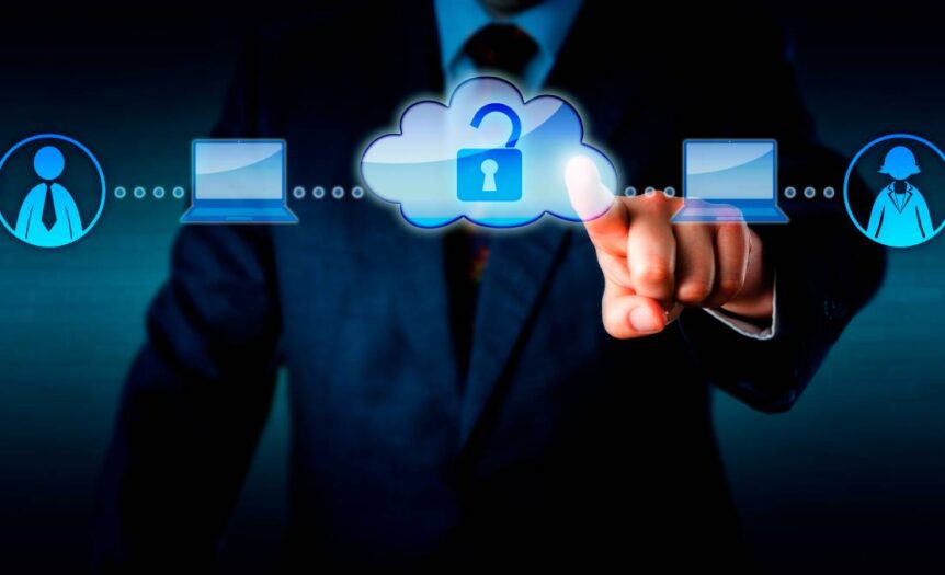 A man in a suit pointing at a graphic of two people connected by laptops and a cloud with an open lock.