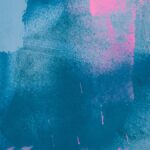 An abstract art piece that focuses primarily on streaks of dark blue with splatters of bright pink. There's no clear subject.