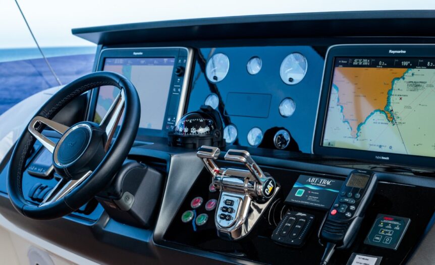The main dash of a boat. The steering wheel, navigation systems, battery switches, remotes, and dials all make up the dash.