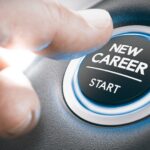 Close-up of a person's hand reaching over with their thumb to hit a glowing button labeled "New Career -- Start."