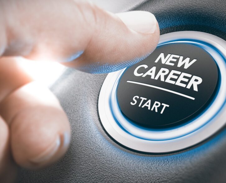 Close-up of a person's hand reaching over with their thumb to hit a glowing button labeled "New Career -- Start."